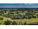 An aerial view of a beautiful golf course community featuring verdant landscaping, several ponds, and luxurious homes at 10600 Indian Hills Ct, Seminole, FL 33777
