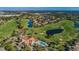 Aerial view of a golf course community with lush fairways, sparkling lakes, and elegant homes at 10600 Indian Hills Ct, Seminole, FL 33777