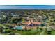 Aerial view of clubhouse with pool, tennis courts, and lush landscaping at 10600 Indian Hills Ct, Seminole, FL 33777