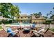 Spacious backyard with in-ground pool, spa, firepit area, and views of the golf course at 10600 Indian Hills Ct, Seminole, FL 33777