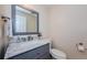 Chic half bathroom with marble countertop, grey cabinetry, and modern fixtures at 10600 Indian Hills Ct, Seminole, FL 33777