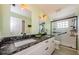 Elegant bathroom featuring double sinks with granite counters and a sleek glass-enclosed shower at 10600 Indian Hills Ct, Seminole, FL 33777