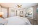 Bright bedroom with a view into the living room, a ceiling fan, and a closet at 10600 Indian Hills Ct, Seminole, FL 33777