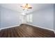 Bedroom with wood floors, closet, ceiling fan and windows with plantation shutters at 10600 Indian Hills Ct, Seminole, FL 33777