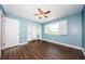 Light blue bedroom with wood floors, closet, ceiling fan and windows with plantation shutters at 10600 Indian Hills Ct, Seminole, FL 33777