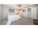 Cozy bedroom featuring plush carpeting, ceiling fan, and closet space, perfect for relaxation and storage at 10600 Indian Hills Ct, Seminole, FL 33777
