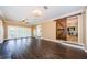 Bonus room with hardwood floors, views of the backyard, a sliding barn door, and staircase at 10600 Indian Hills Ct, Seminole, FL 33777