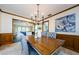 Formal dining room with a chandelier, wood trim, and a view into the living room at 10600 Indian Hills Ct, Seminole, FL 33777