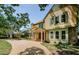 Charming two-story home boasts a stone exterior, mature trees, and a welcoming front porch at 10600 Indian Hills Ct, Seminole, FL 33777