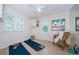 Bright flex room with natural light, tile floors, and storage shelves at 10600 Indian Hills Ct, Seminole, FL 33777