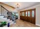 Grand foyer with travertine flooring, staircase, and view into the living room at 10600 Indian Hills Ct, Seminole, FL 33777