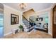 Beautiful foyer with tile floors, stairs, and an entrance to the living room and a mirror at 10600 Indian Hills Ct, Seminole, FL 33777
