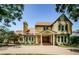 Charming two-story home with a stone facade, mature trees, and a welcoming entrance at 10600 Indian Hills Ct, Seminole, FL 33777