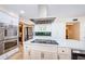 Spacious kitchen featuring stainless steel appliances, white cabinets, and large island at 10600 Indian Hills Ct, Seminole, FL 33777