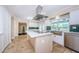 Bright kitchen with a large island, stainless steel appliances, and green backsplash at 10600 Indian Hills Ct, Seminole, FL 33777