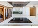Open kitchen featuring stainless steel appliances, white cabinets, and a large island cooktop at 10600 Indian Hills Ct, Seminole, FL 33777