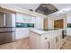 Kitchen featuring stainless steel appliances, white cabinets, and a large island at 10600 Indian Hills Ct, Seminole, FL 33777