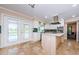 Bright kitchen featuring white cabinets, stainless steel appliances, tile floors, and double doors to the backyard at 10600 Indian Hills Ct, Seminole, FL 33777