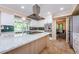 Bright kitchen with a large island, stainless steel appliances, and green backsplash at 10600 Indian Hills Ct, Seminole, FL 33777