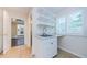 Functional laundry room with a sink, storage, and a view to the backyard at 10600 Indian Hills Ct, Seminole, FL 33777