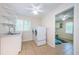 Practical laundry room with sink, washer, dryer, and an organized storage area at 10600 Indian Hills Ct, Seminole, FL 33777