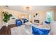 Cozy living room with a fireplace, plush seating, and large windows offering natural light at 10600 Indian Hills Ct, Seminole, FL 33777