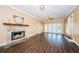 Spacious living room featuring hardwood floors, a stone fireplace, and access to the backyard through glass doors at 10600 Indian Hills Ct, Seminole, FL 33777