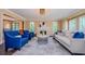 Bright living room features a fireplace, a neutral color palette, and large windows at 10600 Indian Hills Ct, Seminole, FL 33777