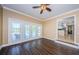 Open living room featuring wood floors, a ceiling fan, and direct access to the outdoor pool and patio at 10600 Indian Hills Ct, Seminole, FL 33777