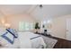 Sunlit main bedroom showcasing high ceilings, plantation shutters, and a cozy seating nook at 10600 Indian Hills Ct, Seminole, FL 33777