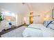 Bright main bedroom featuring vaulted ceilings, barn door access, and a stylish seating area at 10600 Indian Hills Ct, Seminole, FL 33777
