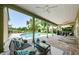 Relaxing patio with seating, overlooking the pool and backyard, perfect for outdoor entertaining and leisure at 10600 Indian Hills Ct, Seminole, FL 33777