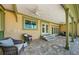 Large brick covered patio with seating, ceiling fans, and a view of backyard at 10600 Indian Hills Ct, Seminole, FL 33777