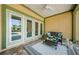Inviting covered patio with stylish furniture, ceiling fan and view of the sparkling pool at 10600 Indian Hills Ct, Seminole, FL 33777