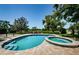 Inviting pool and spa overlook a well-manicured lawn and serene golf course at 10600 Indian Hills Ct, Seminole, FL 33777