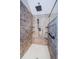 Modern bathroom shower featuring rain shower head, handheld sprayer, and elegant tile surround with shelves at 10600 Indian Hills Ct, Seminole, FL 33777