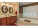 Elegant bathroom featuring double vanity, a soaking tub, and plantation shutters for privacy at 113 Garland Cir, Palm Harbor, FL 34683