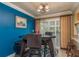 Cozy dining room with dark wood table, bright blue wall, and large windows providing ample natural light at 113 Garland Cir, Palm Harbor, FL 34683