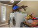 A laundry room featuring a washer and dryer, with built in shelving, and a view out a window at 113 Garland Cir, Palm Harbor, FL 34683