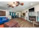 Open-concept living room with blue sofas, a marble fireplace, and dining area with turquoise accents at 113 Garland Cir, Palm Harbor, FL 34683