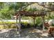 Outdoor living space featuring a pergola, mature tree, and outdoor furniture for relaxation and entertaining at 113 Garland Cir, Palm Harbor, FL 34683