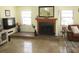 Bright living room features travertine flooring, a decorative fireplace, and lots of natural light at 11906 Lagoon Ln, Treasure Island, FL 33706