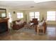 Open living room features travertine flooring, a decorative fireplace, and lots of natural light at 11906 Lagoon Ln, Treasure Island, FL 33706