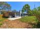 Spacious backyard featuring a patio area with grill, mature trees, and a partially covered area for outdoor enjoyment at 12536 116Th St, Largo, FL 33778