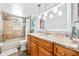 Bright bathroom featuring wood flooring, a granite vanity, and a shower-tub with travertine tile at 12536 116Th St, Largo, FL 33778