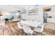 Spacious dining area open to living room and kitchen features wood floors and a modern chandelier at 12536 116Th St, Largo, FL 33778