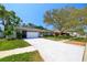 Charming one-story home featuring a well-maintained lawn and a spacious driveway leading to a two-car garage at 12536 116Th St, Largo, FL 33778