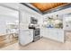 Open kitchen features white cabinets, stainless steel appliances, and access to the living area at 12536 116Th St, Largo, FL 33778