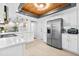 Modern kitchen featuring white cabinets, stainless steel appliances, and a decorative wood ceiling at 12536 116Th St, Largo, FL 33778