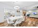 Living room and dining area with stone fireplace, modern lighting, and hardwood flooring at 12536 116Th St, Largo, FL 33778